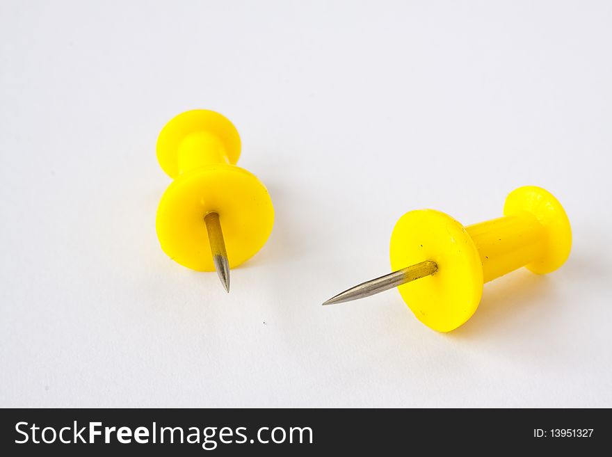 Two pushpins on white background