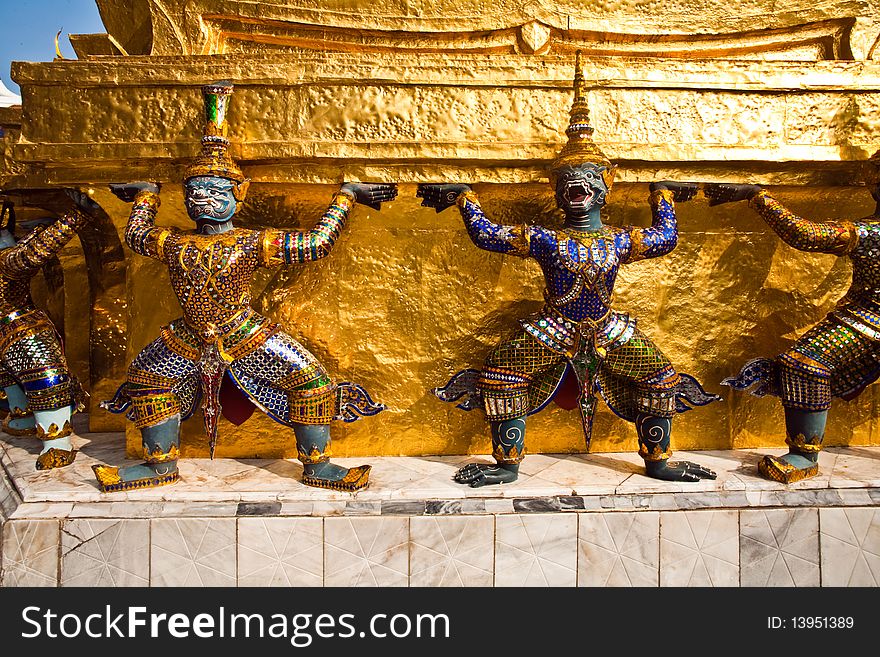 Golden guards are holding the chedi in the inner Grand Palace