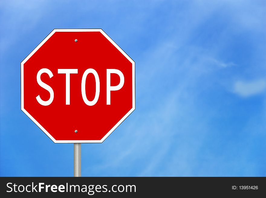 A stop sign against a blue sky.