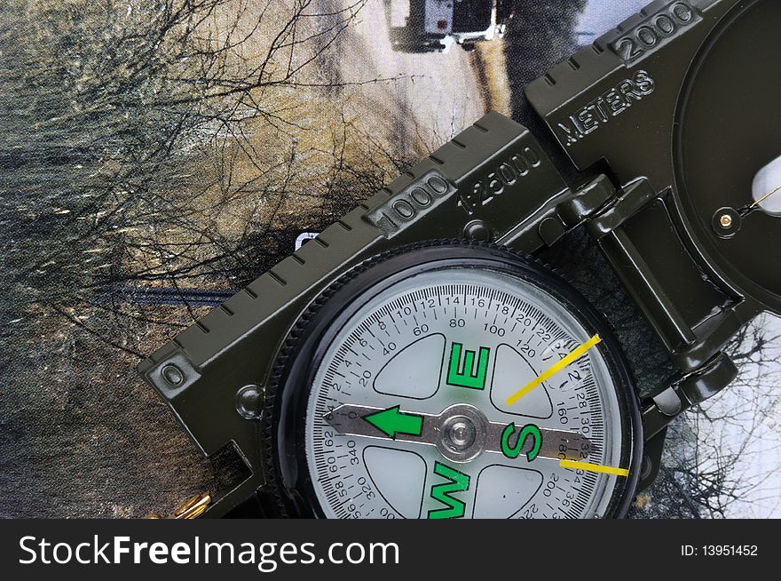 A compass with range finder, putting on a travel image, means outting, travel, exploration, tour, trudge concept. A compass with range finder, putting on a travel image, means outting, travel, exploration, tour, trudge concept.