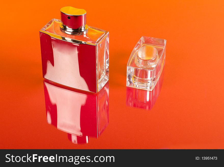Bottle of perfume isolated on the red