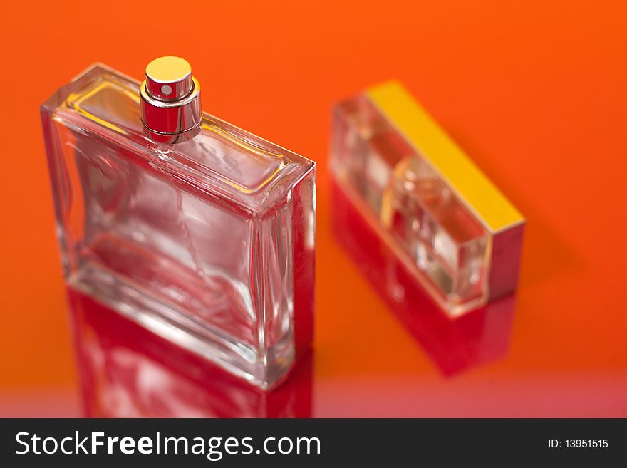 Bottle of perfume on the red. Bottle of perfume on the red