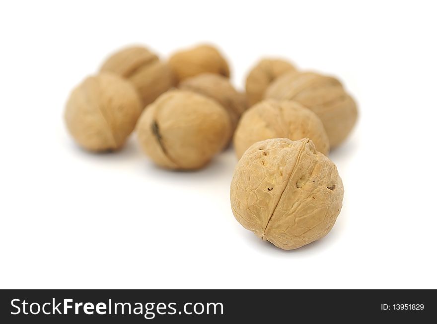 A pile of walnuts isolated on a white background