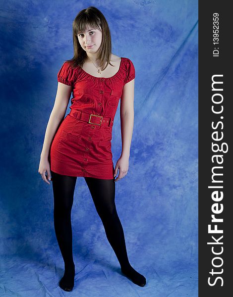 Teenage girl in red on a blue background. Teenage girl in red on a blue background