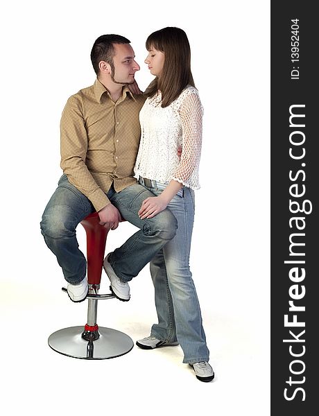 Young man sitting on a chair and looking at his girlfriend. Young man sitting on a chair and looking at his girlfriend