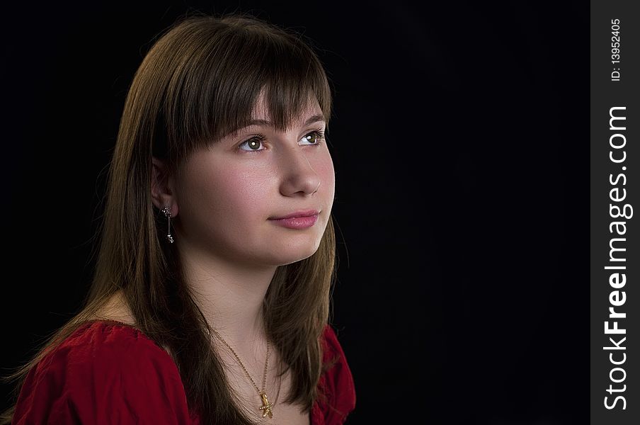 Beautiful girl looking away on a black background. Beautiful girl looking away on a black background