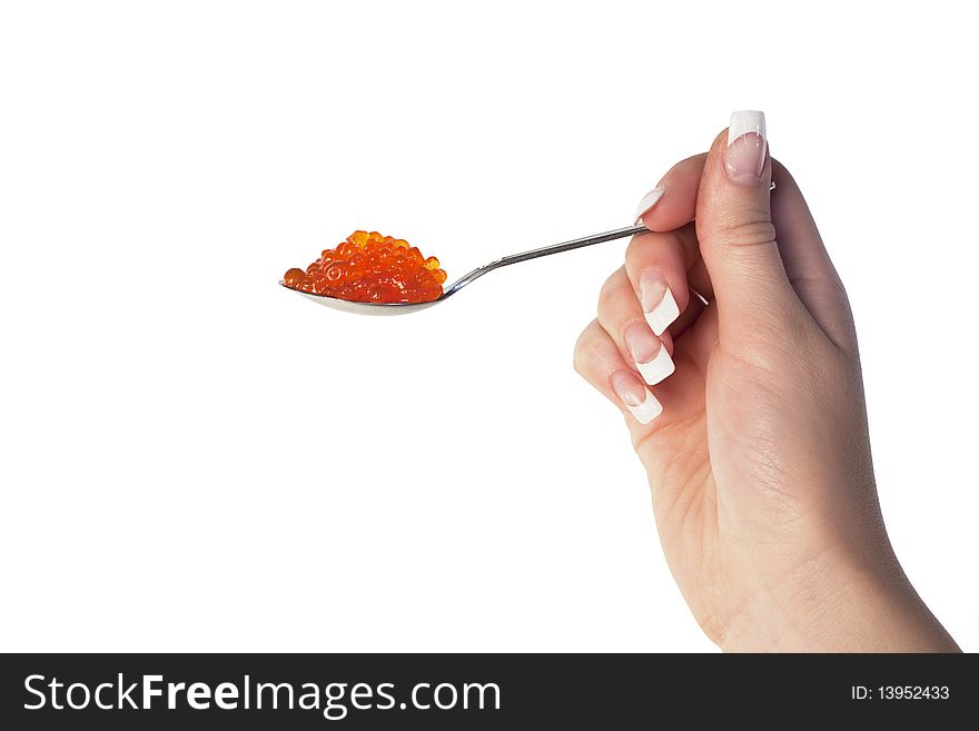 Human hand holding a spoon with red caviar