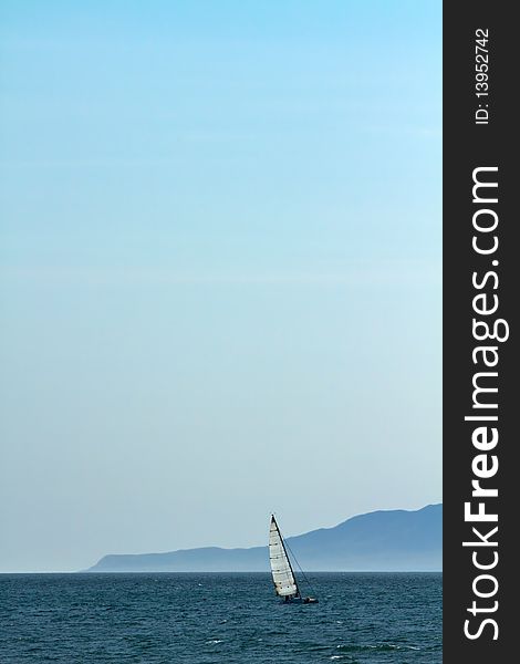 Solitary sailboat at sea on Pacific Ocean. Solitary sailboat at sea on Pacific Ocean.