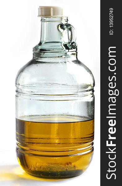 Olive oil in glass container. Olive oil is essential in many foods mostly ones situated on the Mediterranean. Olive oil in glass container. Olive oil is essential in many foods mostly ones situated on the Mediterranean