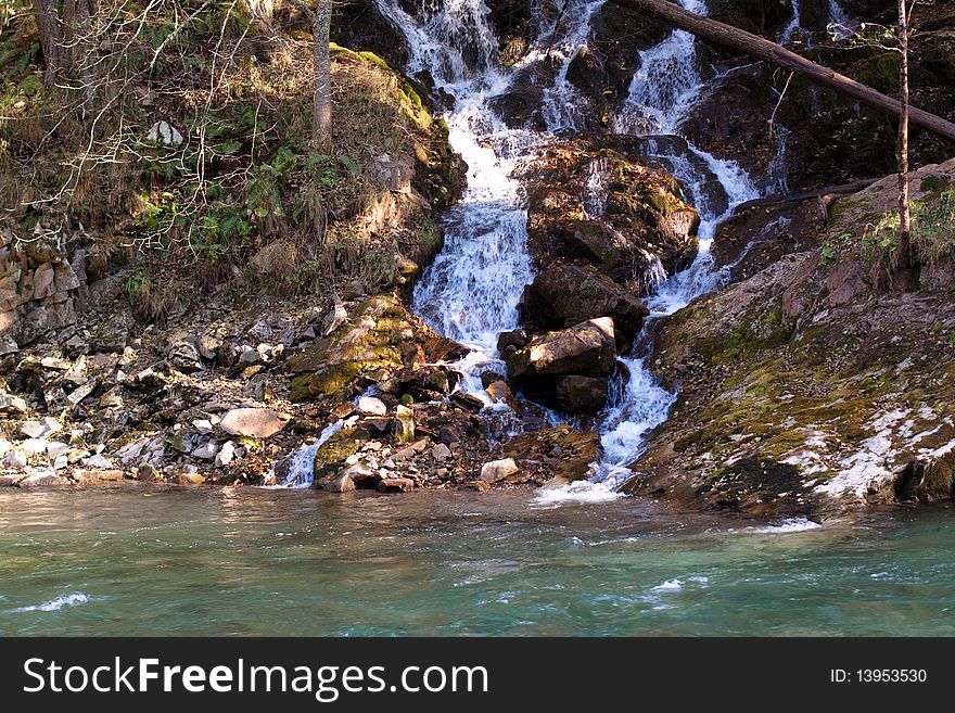 Small waterfall, trees and river