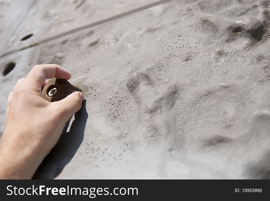 Freeclimber hanging on grip