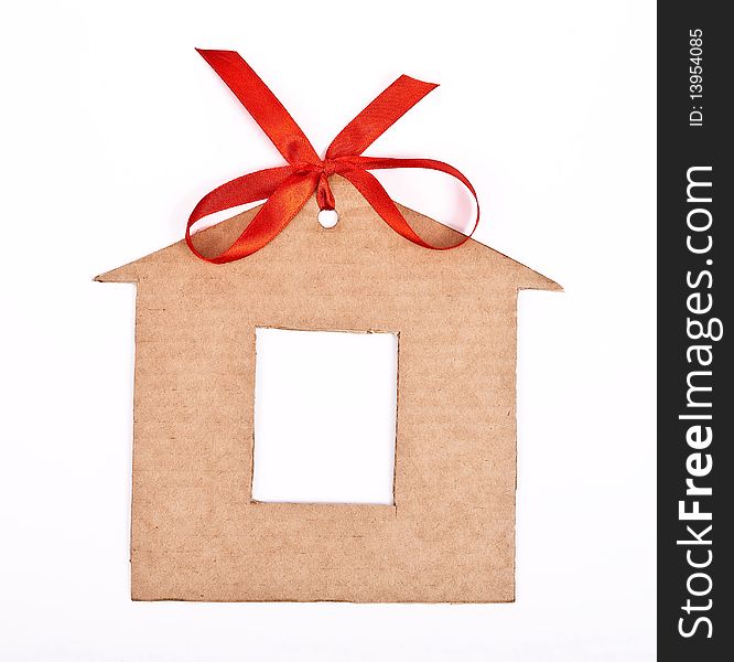 Cardboard house with red ribbon and bow