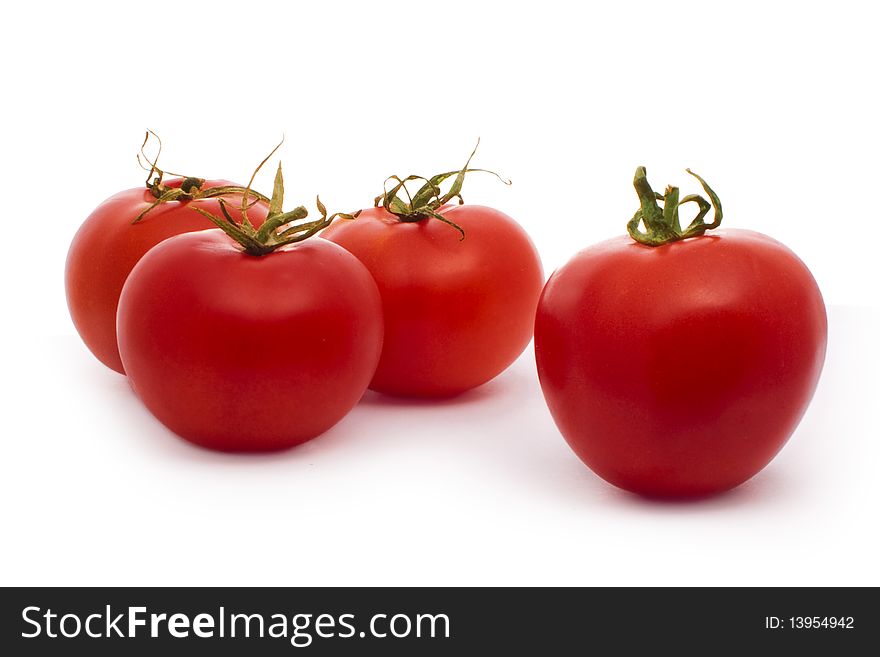 Four red tomatoes isolated on white. Four red tomatoes isolated on white