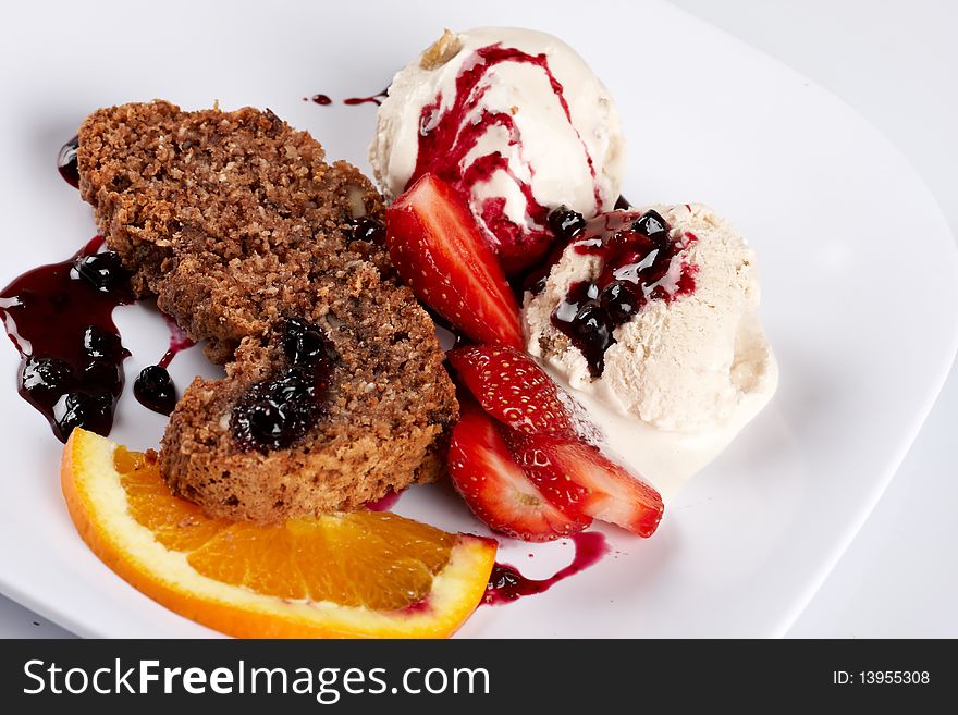 Slice of chocolate cake with fruits and ice cream. Slice of chocolate cake with fruits and ice cream