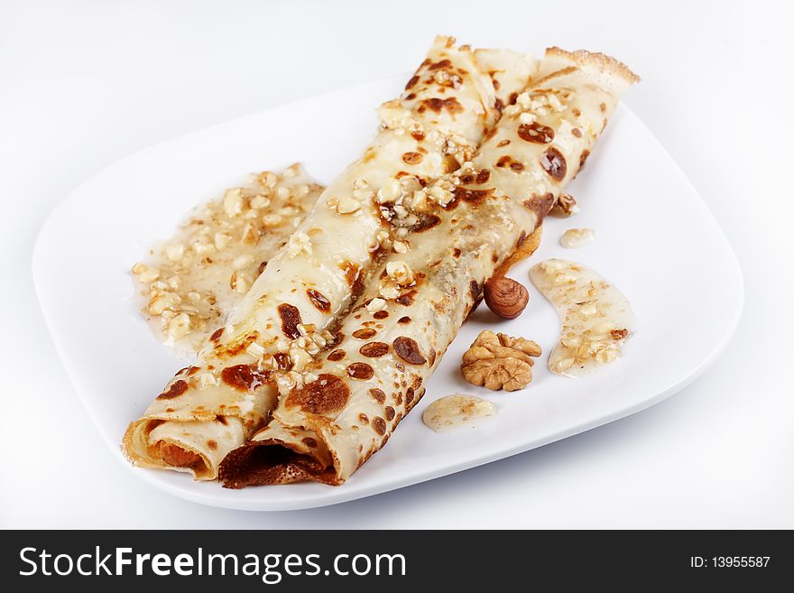 Pancakes covered with honey and nuts
