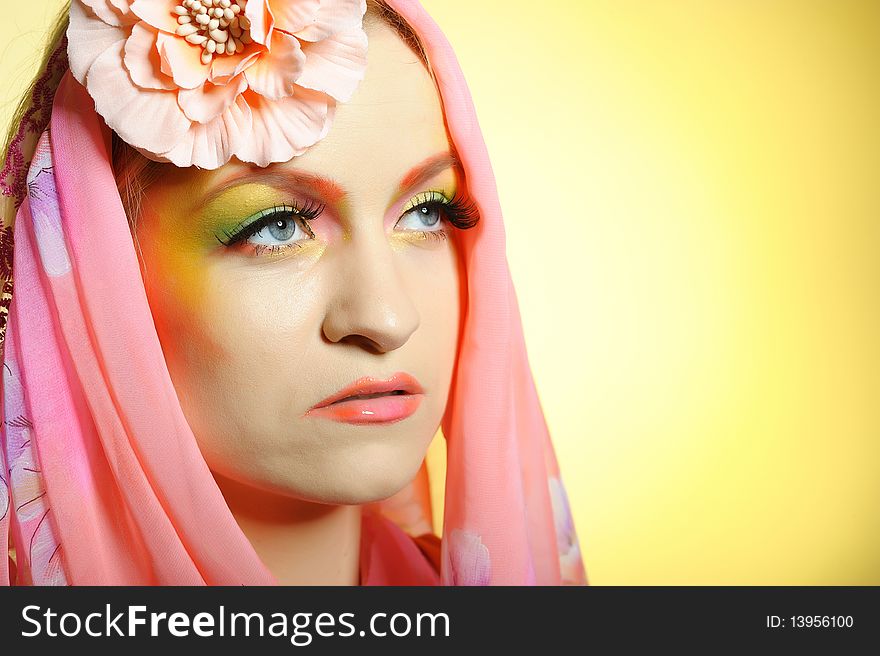 Close-up portrait of summer fashion creative eye make-up in yellow and green tones. Close-up portrait of summer fashion creative eye make-up in yellow and green tones