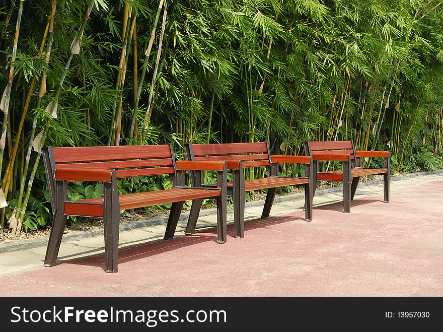 A row of thee woodern chair. A row of thee woodern chair.