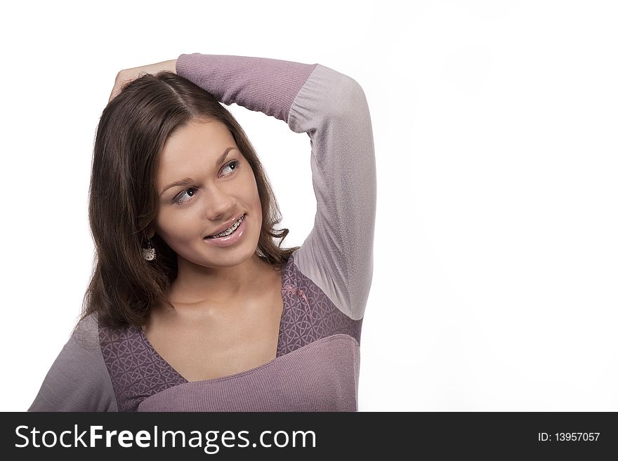 Young cute girl treatment process while wearing brackets standing with sincere smile isolated over white background. Young cute girl treatment process while wearing brackets standing with sincere smile isolated over white background