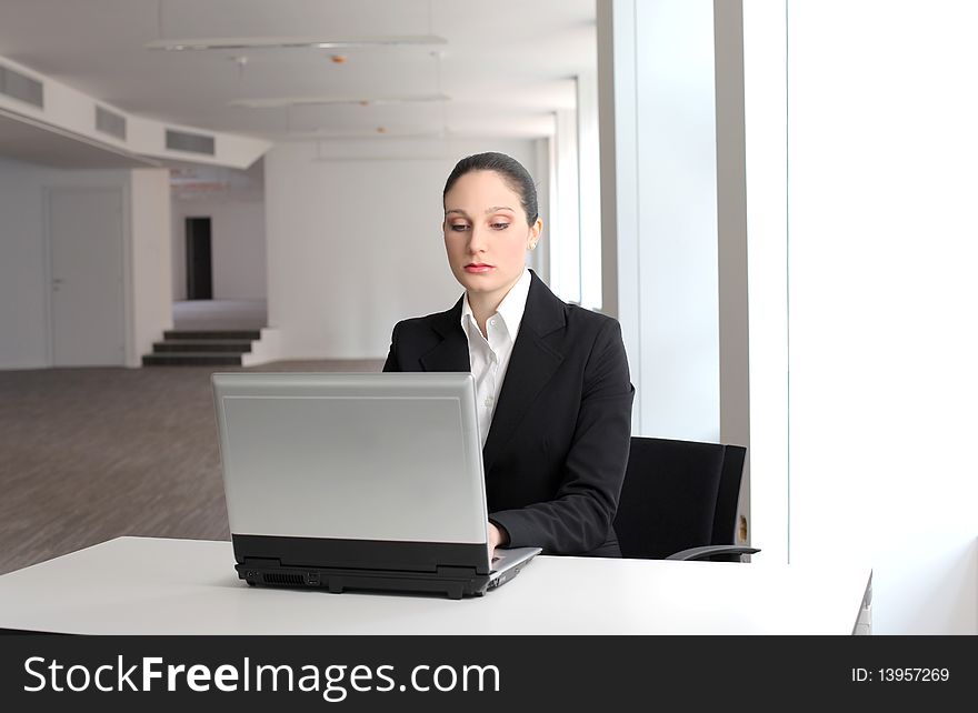 Businesswoman sitting in front of a laptop. Businesswoman sitting in front of a laptop