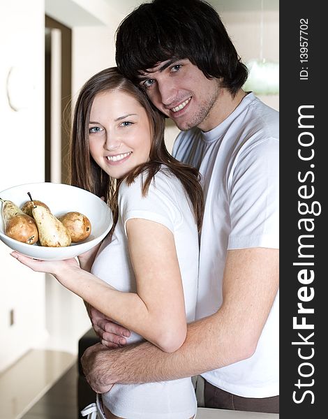 Boy with smile and beautiful girl with plate