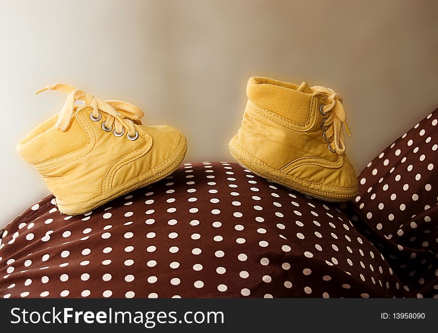 Baby shoes on pregnant mother's belly