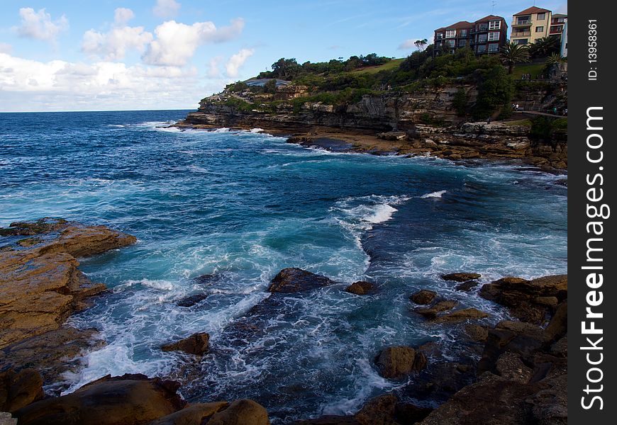 Over looking the beach and cliffs set of apartments on summer day. Over looking the beach and cliffs set of apartments on summer day