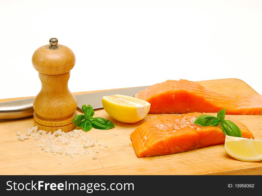 Fresh salmon fillets on chopping board