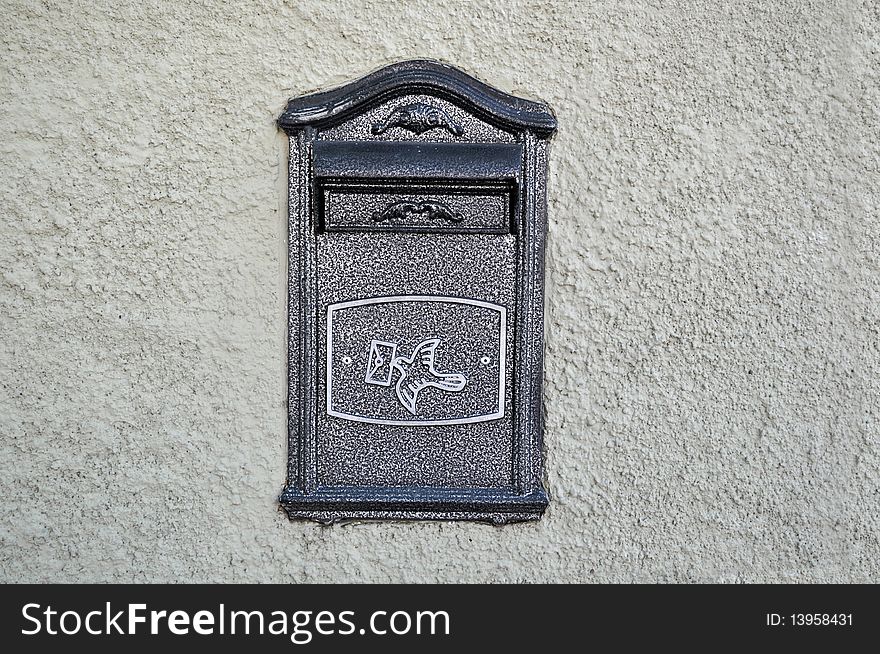 Textured wall with metal mailbox
