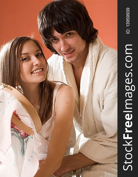 Girl with smile and boy in white dressing gown. Girl with smile and boy in white dressing gown