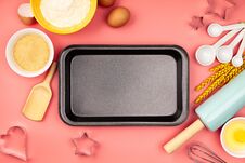 Baking Ingredients And Empty Baking Tray On Pink Background, Flat Lay Royalty Free Stock Photography