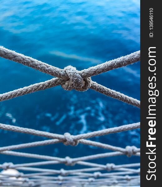 Close up pier fence rope detail. Blue sea. Perspectival view. Turkey. Close up pier fence rope detail. Blue sea. Perspectival view. Turkey