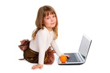 Little Girl With Laptop And Orange Royalty Free Stock Photos