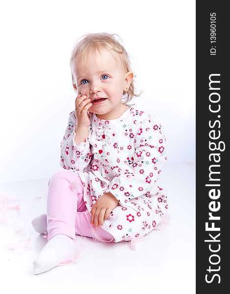 Sweet happy little girl sit over white background