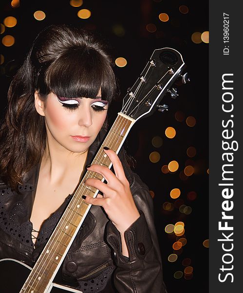 The young girl with a guitar on a roof of a high-rise building. The young girl with a guitar on a roof of a high-rise building