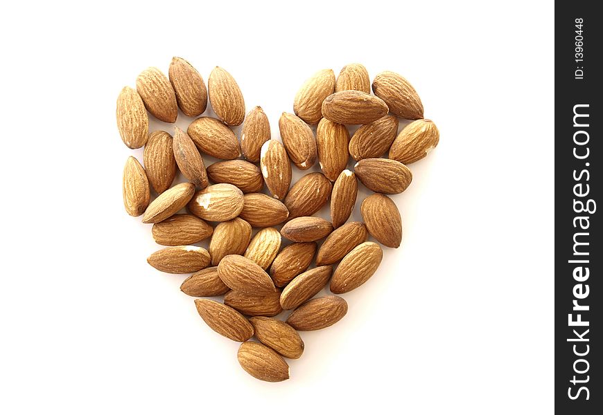 A heart made of almonds on white background. A heart made of almonds on white background