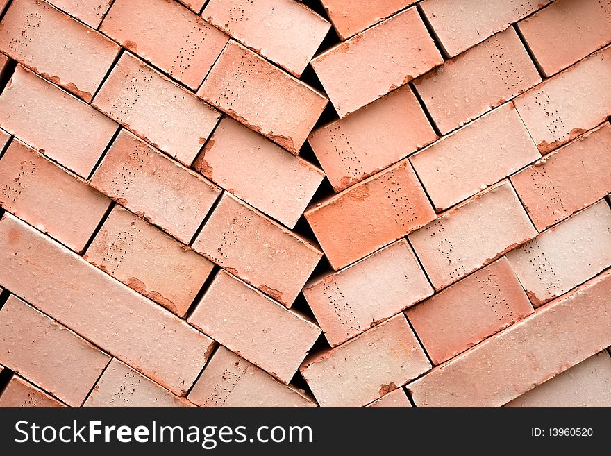 Background of many red bricks for cinstruction in a pallet