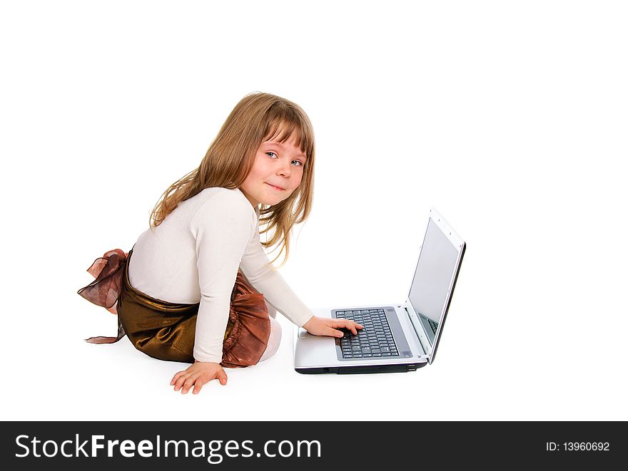 The sitting little girl with the laptop on white