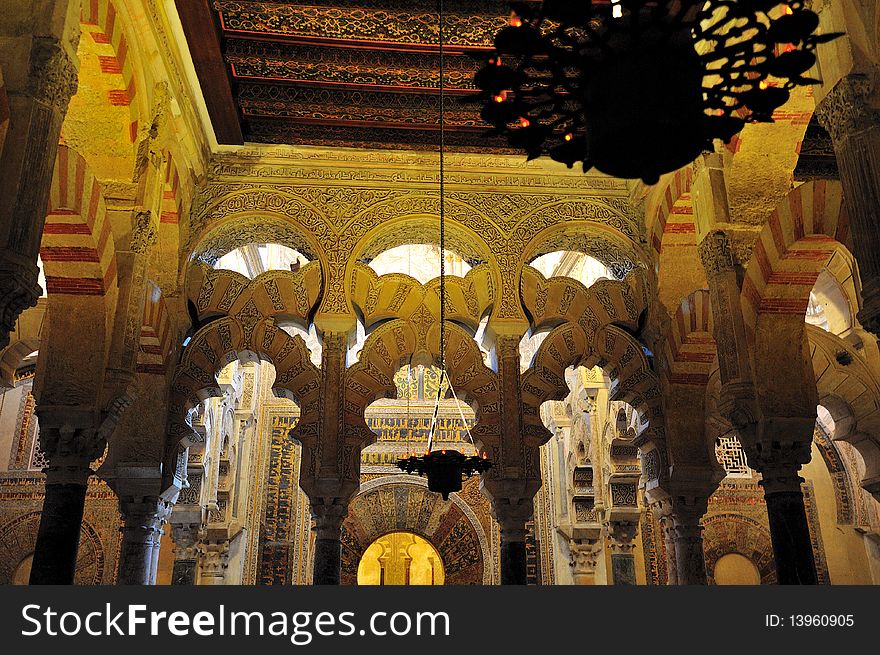 Cordoba's Mezquita is a Blend of Moorish and Christian Architecture.Sunlight streams in from windows in the four cupolas creating interesting effects combined with artificial light from the thousands of small oil lights. Cordoba's Mezquita is a Blend of Moorish and Christian Architecture.Sunlight streams in from windows in the four cupolas creating interesting effects combined with artificial light from the thousands of small oil lights.