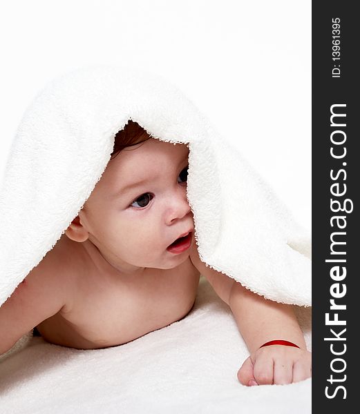 Portrait of the little boy under a terry towel