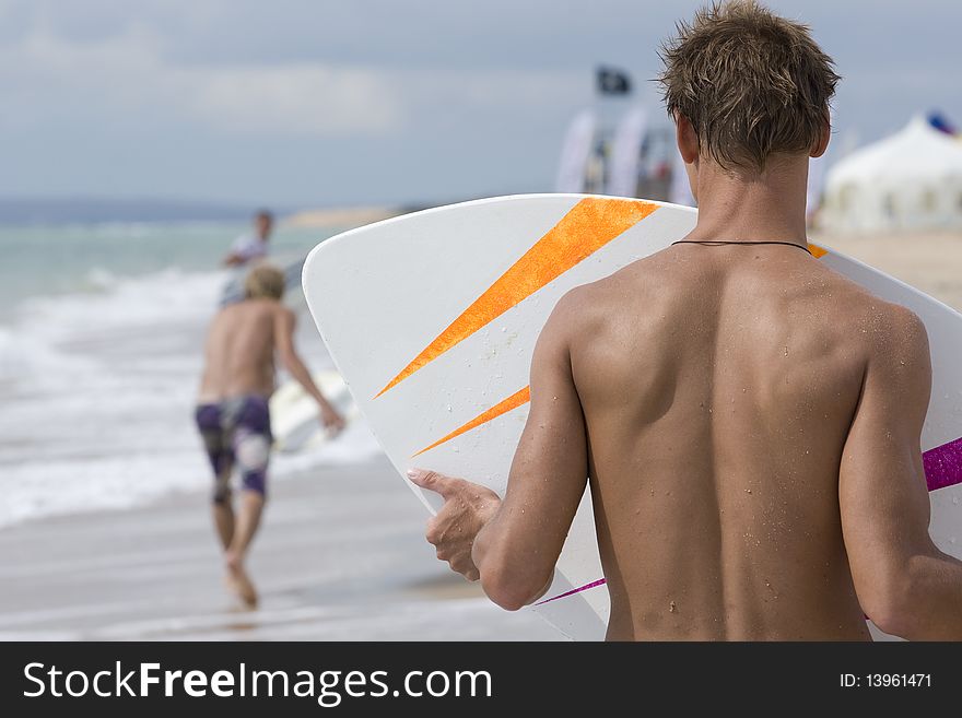 Two yong surfer riding on coastal waves