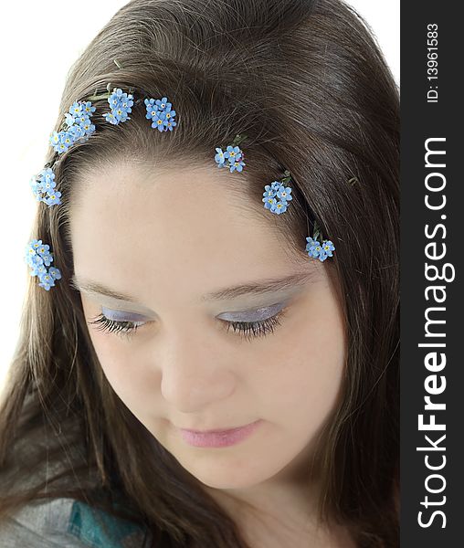 Portrait of young woman with forget-me-not flowers in her hair. Portrait of young woman with forget-me-not flowers in her hair