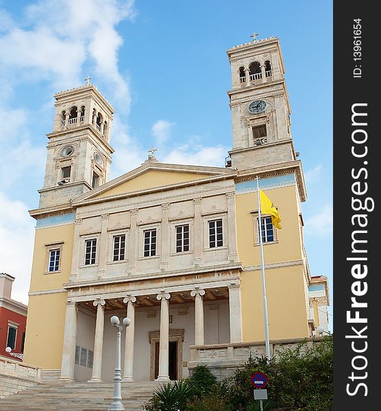 The Greek Orthodox church with two towers on the island of Syros against the blue sky. The Greek Orthodox church with two towers on the island of Syros against the blue sky