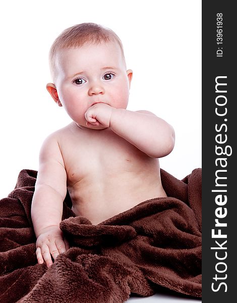 A beautiful baby with brown towel on white background