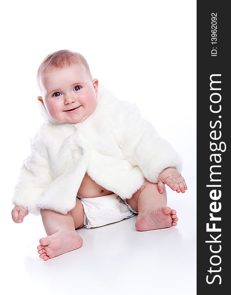 Cute little girl with a warm coat on white background