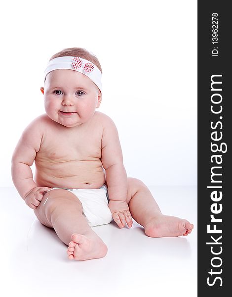 Little baby sitting on white background