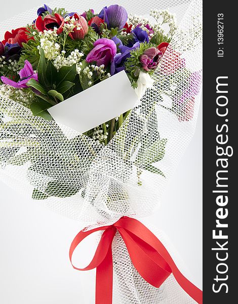 Beautiful bouquet of flowers with blank white card to put your message.