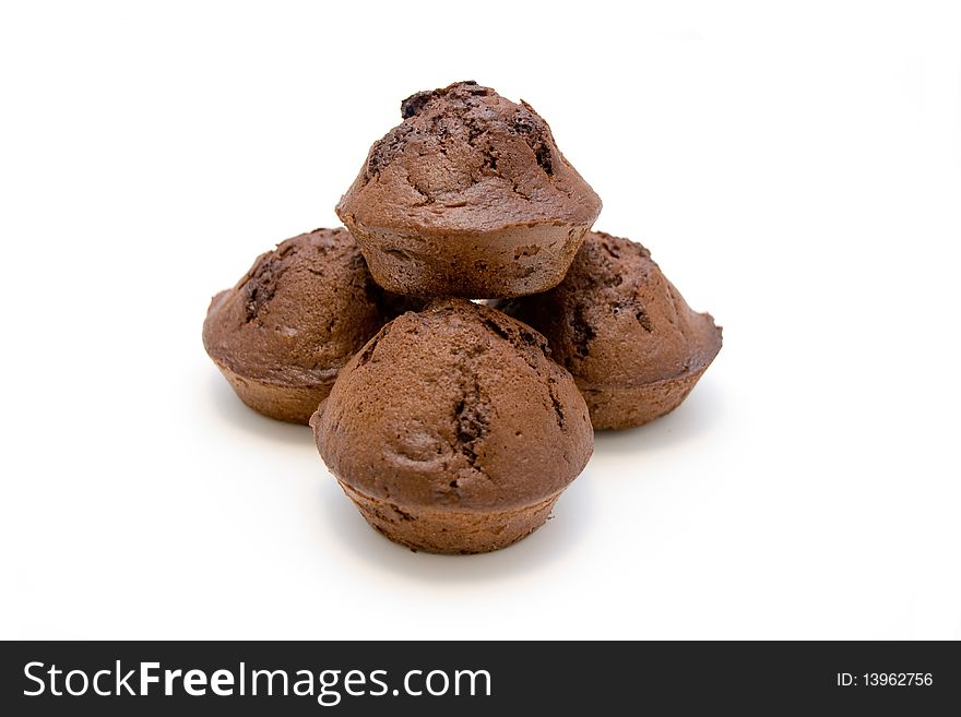 Pile of chocolate muffins isolated on white.