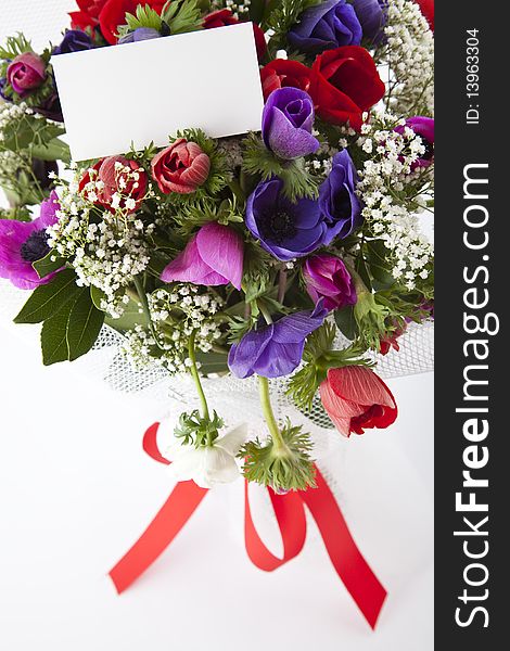 Beautiful bouquet of flowers with blank white card to put your message.