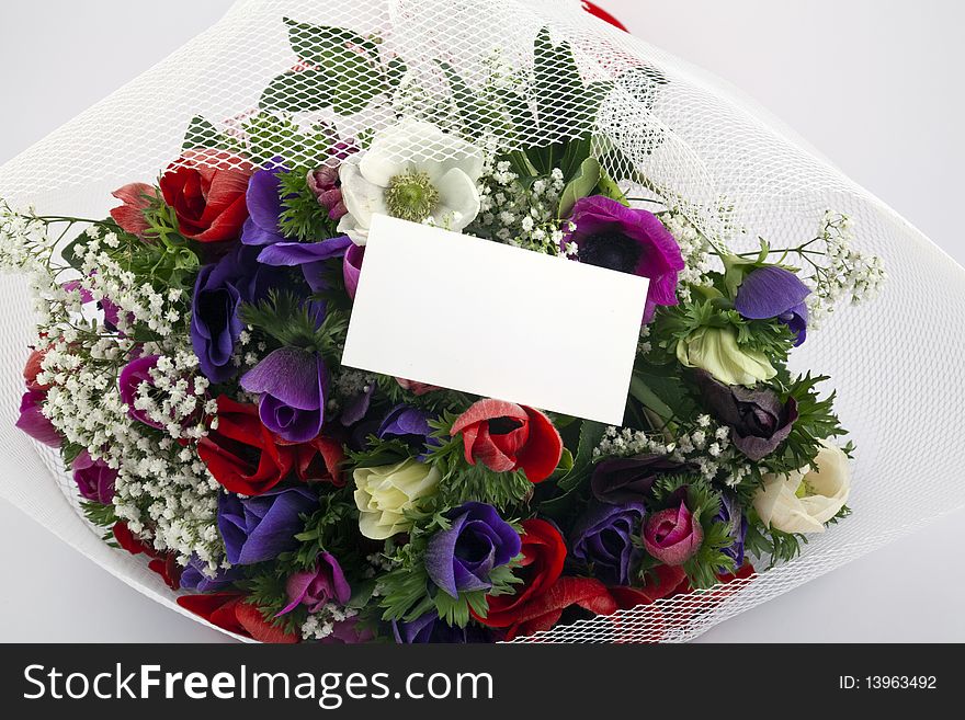 Beautiful bouquet of flowers with blank white card to put your message.