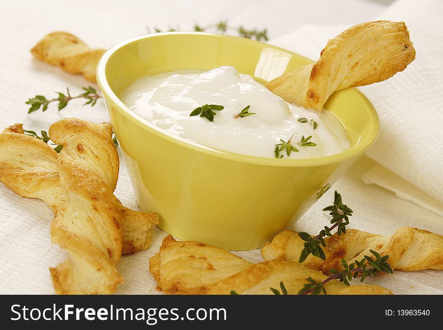 Cheese sticks served with white yogurt and fresh thyme